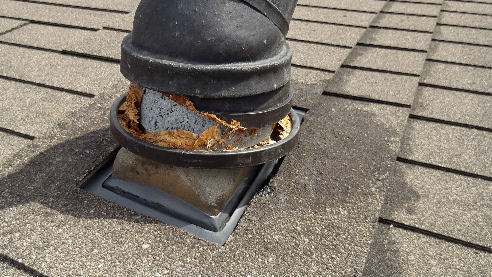 A cracked rubber pipe boot around a vent stack, one of the most common causes of a roof leak