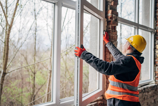 Installer fitting a new energy-efficient replacement window
