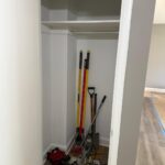 Closet storage installation with shelf and hanging rod setup.