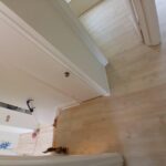 Entryway area with new hardwood flooring and clean white trim details.